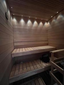 a sauna with a wooden bench in a room at Three Monkeys Loft in Hyvinkää