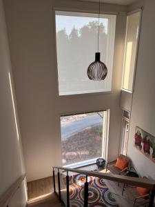 a room with a large window and a pendant light at Three Monkeys Loft in Hyvinkää