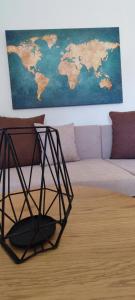 a living room with a couch and a map of the world at Maria's Luxury Apartment in Kassandra