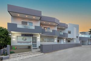 a large white building with a sign in front of it at Savvas Apartment in Afantou