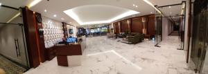 a lobby with a white marble floor and a room at نمار هوم للاجنحة المخدومة -طويق in Riyadh