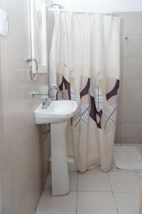 a bathroom with a sink and a shower curtain at Narcizo in Lules