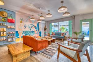 a living room with furniture and a painting on the wall at Bocas Paradise Hotel in Bocas del Toro