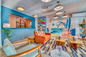a living room with a surfboard mural on the wall at Bocas Paradise Hotel in Bocas del Toro