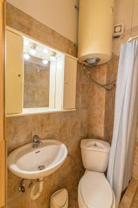 a bathroom with a sink and a toilet and a mirror at Sunday Mood in Nea Skioni +100 photos
