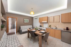 a kitchen and living room with a table and chairs at Savvas Apartment in Afantou