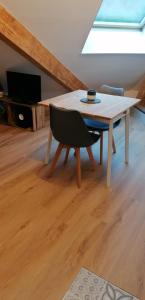 a dining room with a table and a chair at Location appartement T2 38 m2 2 chambres in Allevard