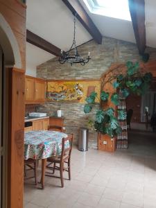 a kitchen with a table and a dining room at Villa authentique à Patrimonio in Patrimonio