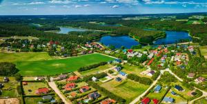 an aerial view of a village with a lake at KASZUBY Oliwkowy domek Niesiołowice na Kaszubach Balia z Jacuzzi Jeziora lasy in Niesiołowice