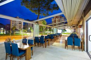 a restaurant with blue chairs and tables and windows at Villa Vanilla Hotel & SPA Istanbul Asia in Istanbul