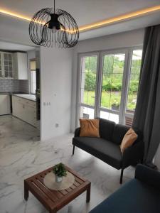 a living room with a couch and a table at Wellnesshouse Müller in Ilindentsi +30 photos