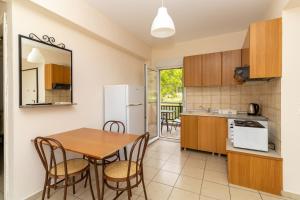 a kitchen and dining room with a table and chairs at Sunday Mood in Nea Skioni
