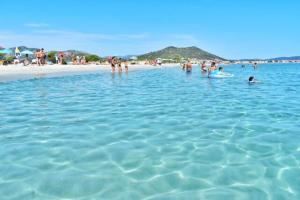 a group of people in the water at a beach at Casa di Ale in Siniscola