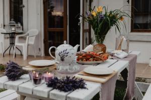 uma mesa com uma chaleira e um prato de comida em Lawendowe Domki Mielno em Mielno