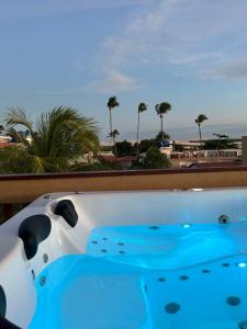 a hot tub with a view of the beach at Pousada Amazing Jeri in Jericoacoara