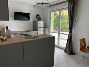 a kitchen with a counter and a large window at L'Etoile in Lutterbach