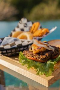 a table with a sandwich and other food on it at Casa Mauna Boutique Hotel in Cuatunalco