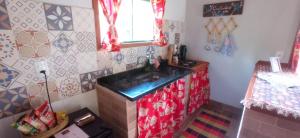 a kitchen with a sink in a room with tiles at POUSADA CHALÉS DA GROTA de SÃO PEDRO DA SERRA- NOVA FRIBURGO in Nova Friburgo +35 photos