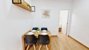 a dining room with a table and four chairs at Villa Candari in Chiclana de la Frontera