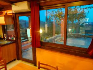 a room with two windows and a view of a patio at Casa Vacanze Panoramika Santa Cruz - Appartamento SANTA CRUZ in Cicerale