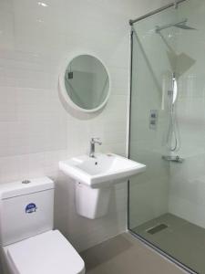 a bathroom with a toilet and a sink and a shower at Abi's Place in Tungan Ali