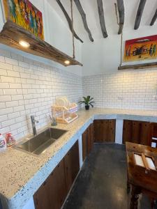 a kitchen with a sink and a counter at Bitcoin Beach Hotel Zanzibar in Pingwe