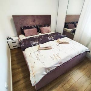 a bedroom with a large bed with two pillows on it at VIP Apartment in Jagodina