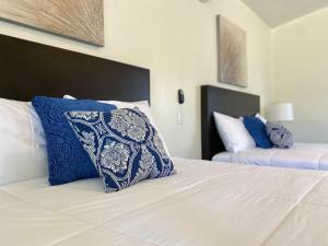 a bedroom with a blue and white pillow on a bed at Casa Anguiano Valle de Guadalupe in Valle de Guadalupe