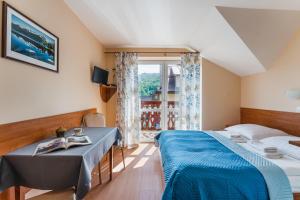 Postel nebo postele na pokoji v ubytování Willa Szarotka B&B + 5 fotografií