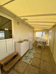 a kitchen with a sink and a table at Camping Mayer in Cavallino-Treporti