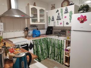 a kitchen with a white refrigerator and a sink at veronica in Llaurí