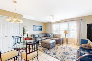 a living room with a couch and a table at Three C's 202 in Gulf Shores