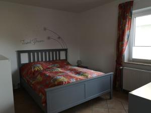 a bedroom with a bed with a comforter on it at Ferienwohnung Hermann in Bovenden