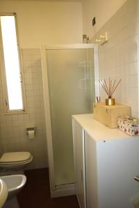 a bathroom with a toilet and a sink at BlancoHouse Viale Ceccarini in Riccione