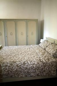 a bedroom with a bed with a brown and white blanket at BlancoHouse Viale Ceccarini in Riccione