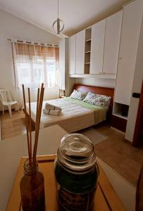 a bedroom with a bed and a jar on a table at Praia Sea Home, Casa Vacanze in Praia a Mare