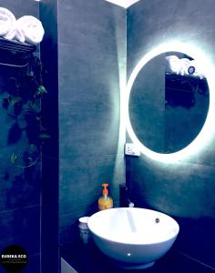 a bathroom with a white sink and a mirror at Eureka Eco in Hue
