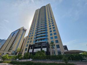 a tall building with palm trees in front of it at 2 BHK @ Barsha Heights in Dubai