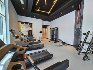 a gym with several treadmills and cardio machines at 2 BHK @ Barsha Heights in Dubai