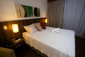 En eller flere senge i et værelse på Apartamento, Nobile Suítes Monumental , localização e conforto + 24 billeder