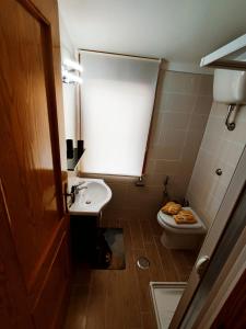 a small bathroom with a toilet and a sink at Praia Sea Home, Casa Vacanze in Praia a Mare +24 photos
