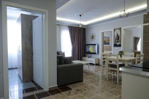 a living room with a couch and a table at Fishta apartments Q5 32 in Velipojë