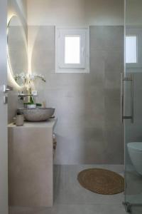 un bagno con lavandino e specchio di MFP Dryos Paros House Project a Drios
