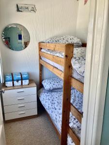 a bedroom with a bunk bed and a mirror at Pensilva in Hayle