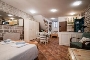 a bedroom with two beds and a kitchen and a room at Lito Apartments Sibenik in Šibenik