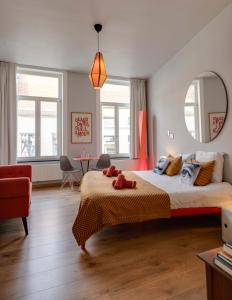 a bedroom with a large bed and a mirror at B&B Belle de Nuit in Ostend