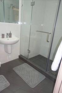 a bathroom with a shower and a sink at The Gallery by Luxury Stay in Accra