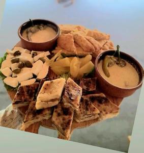un plato de comida con queso, galletas y salsas en Mulliri en Peje