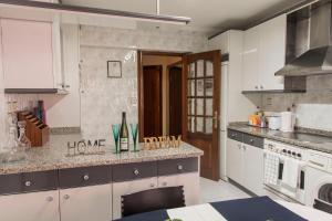 a kitchen with white cabinets and a counter top at Bilbao céntrico 2h Landeta in Bilbao