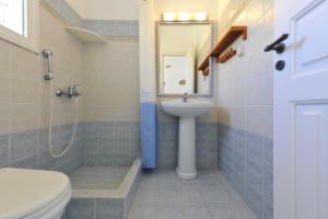a bathroom with a sink and a toilet and a shower at Degaetas Resort in Antiparos